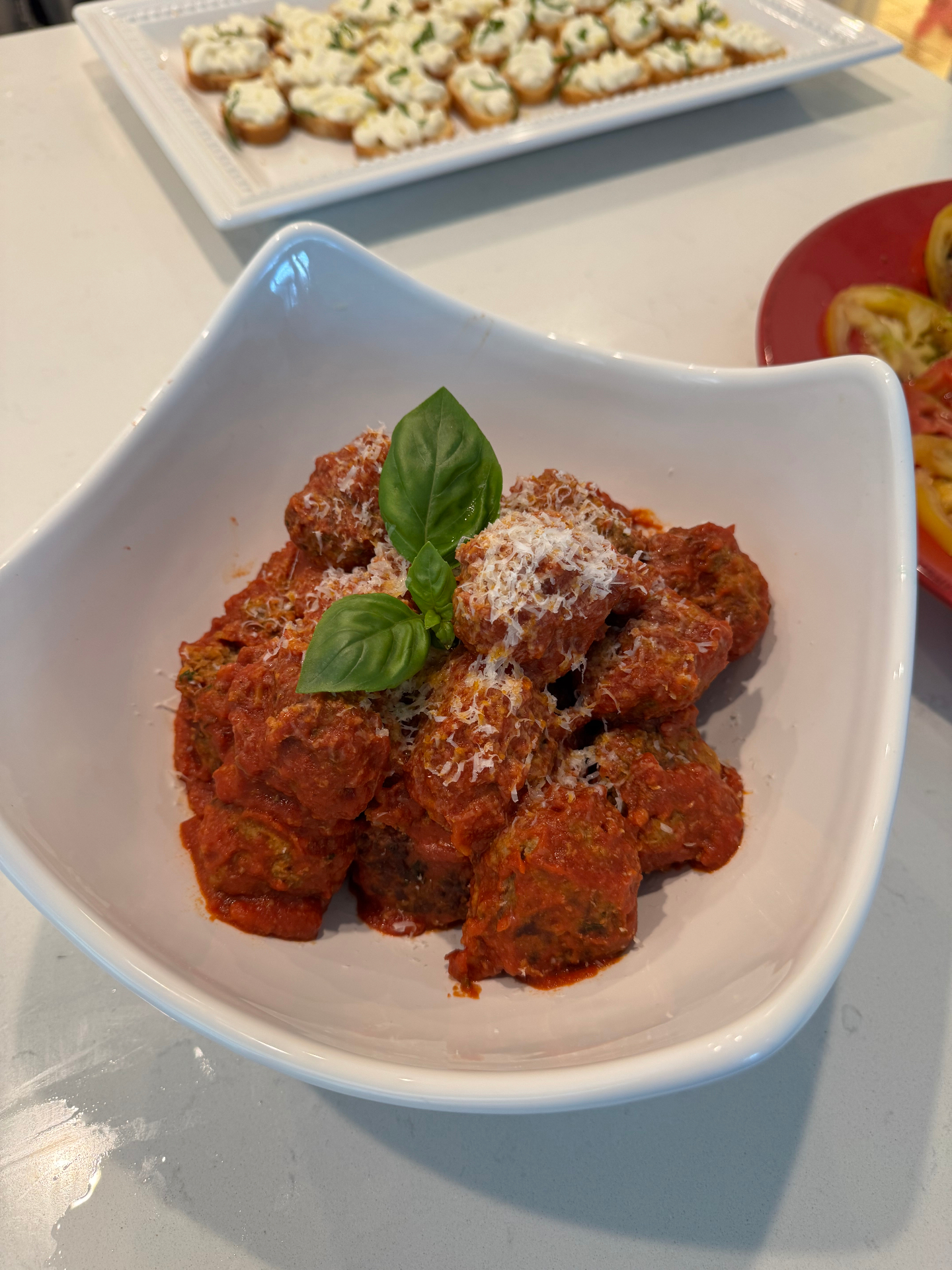 Tender meatballs in rich tomato sauce topped with fresh basil and parmesan